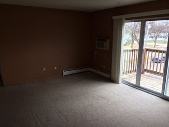 Living Room With Balcony at Southern Manor Apartments, Grand Forks, North Dakota